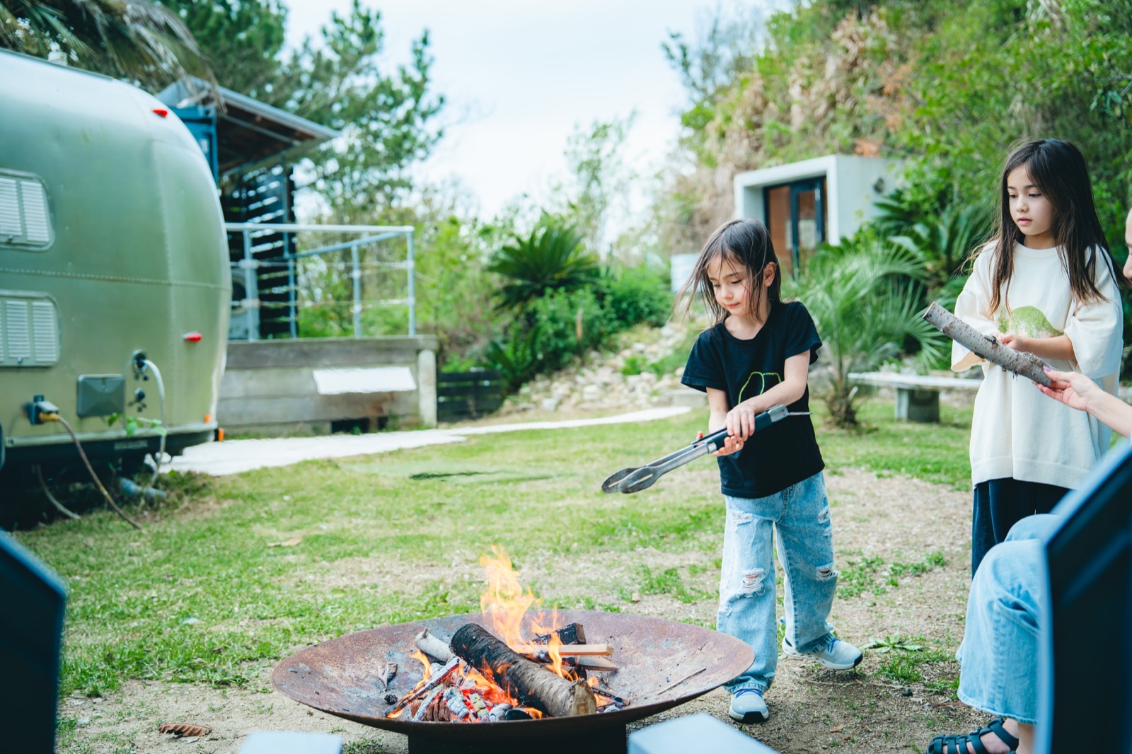エアストリームの近くで焚き火を囲む
